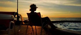 Managua Nicaragua Gran Pacifica woman in chair at pool at sunset at beach – Best Places In The World To Retire – International Living